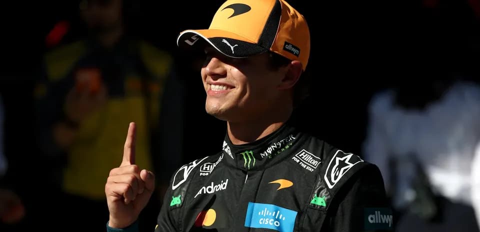 Driver celebrating with a finger raised in victory