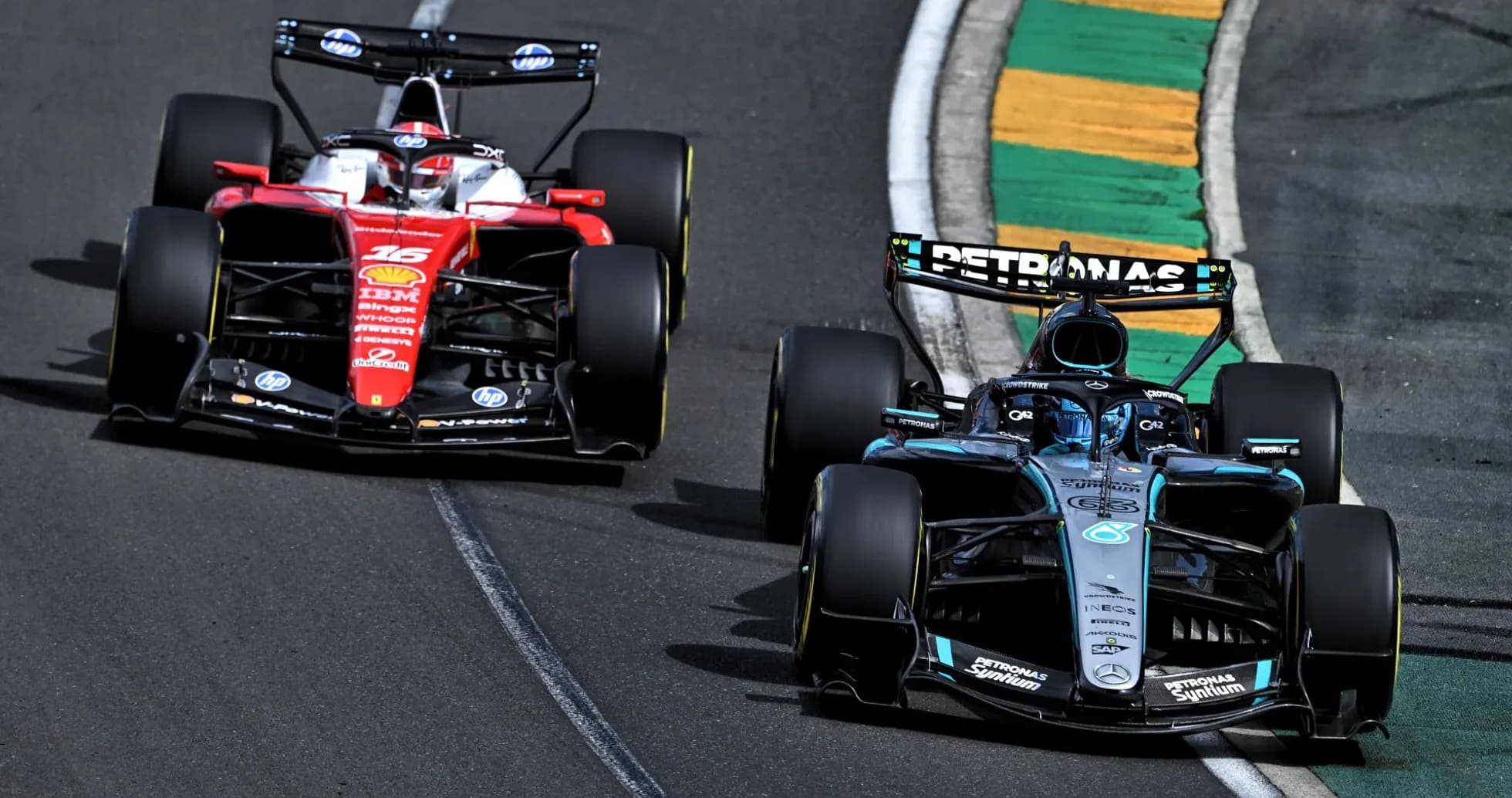 Two Formula 1 cars racing on track corner