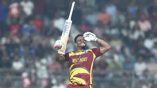 Cricketer celebrating with bat in hand