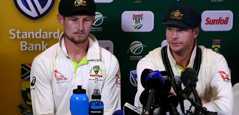Australian cricketers at press conference with microphones