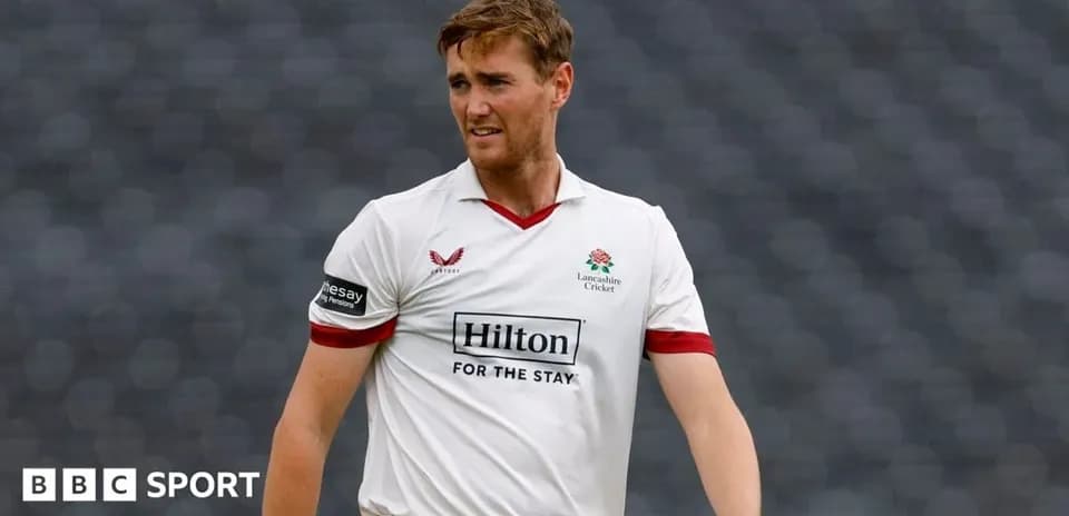 Cricketer in Lancashire kit walking on the field
