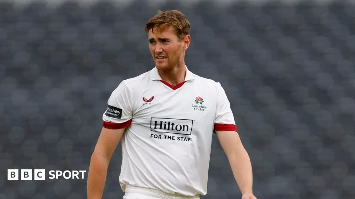 Cricketer in Lancashire kit walking on the field