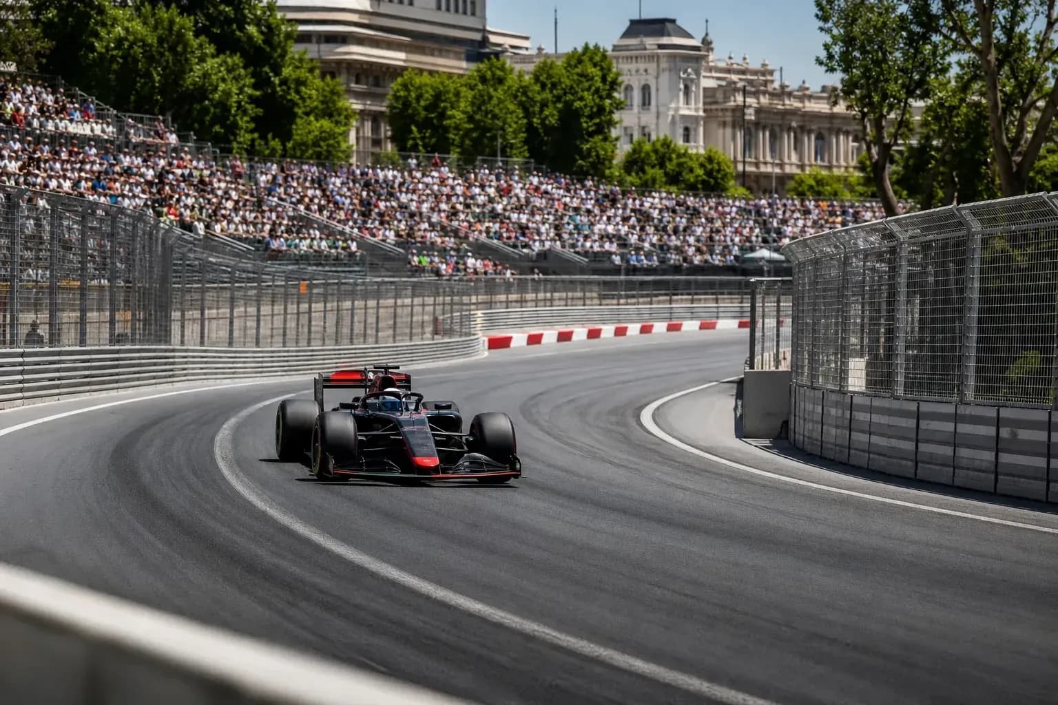 Formula 1 car navigating a turn on racetrack