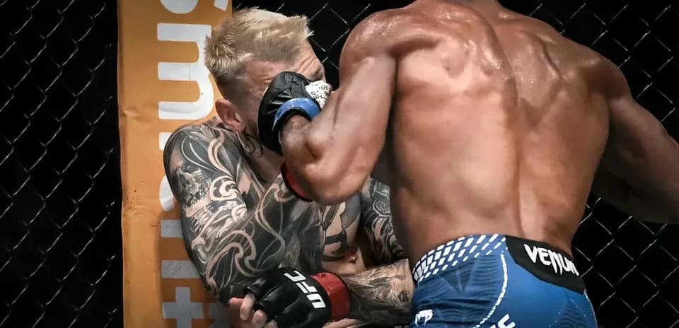 Two fighters exchanging blows in UFC octagon