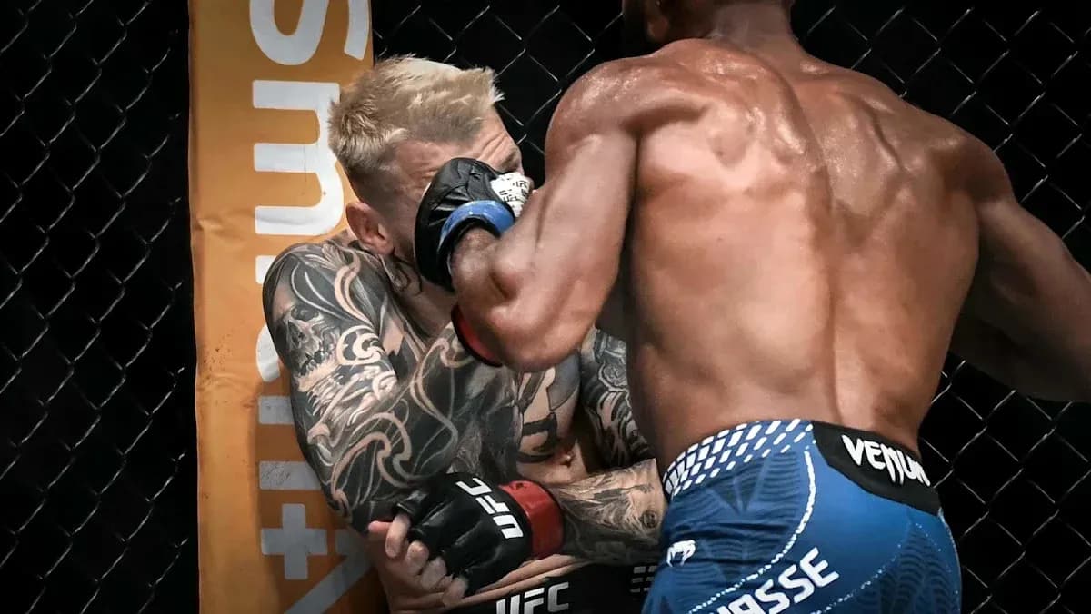 Two fighters exchanging blows in UFC octagon