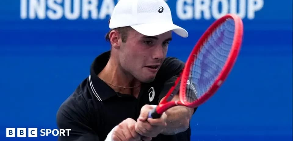 Tennis player hitting a forehand shot during match