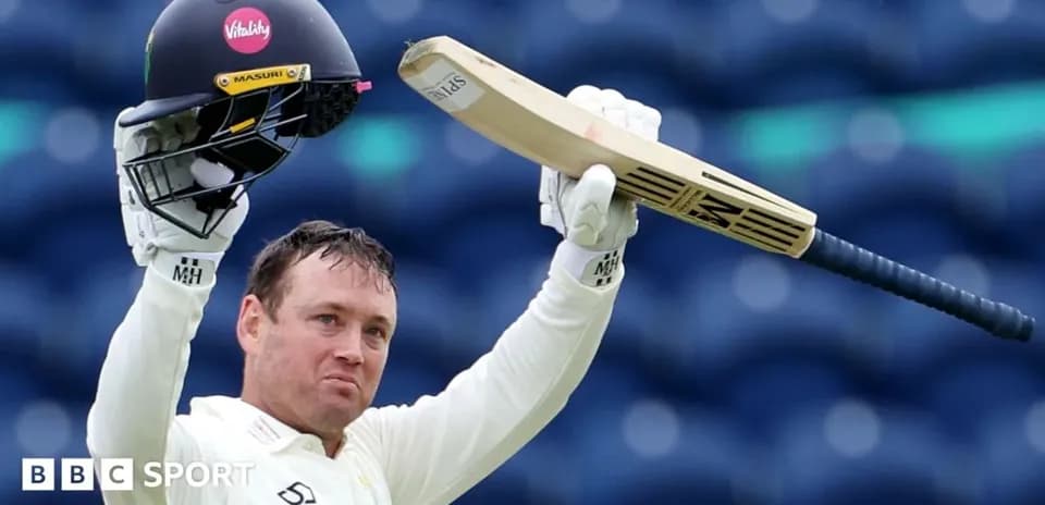 Cricketer celebrating with helmet and bat raised