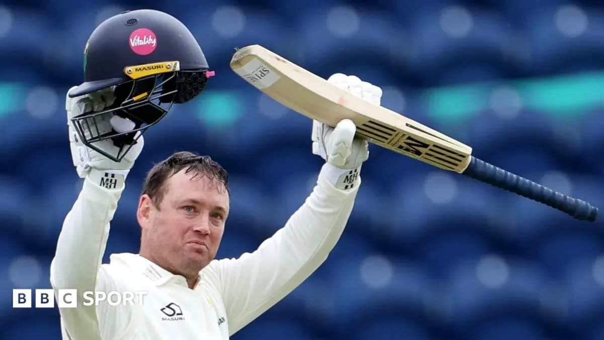 Cricketer celebrating with helmet and bat raised