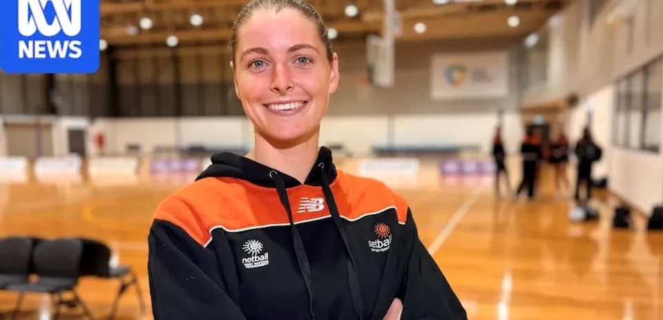Netball player smiling in training facility
