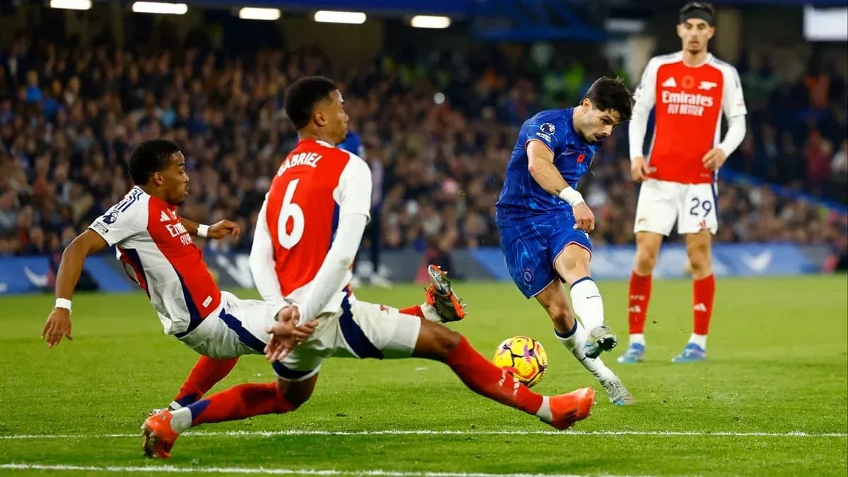 Chelsea player shooting at goal with defenders nearby