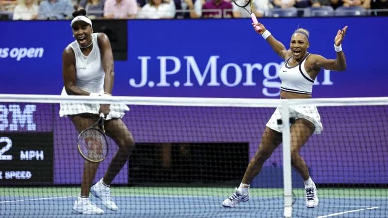 Venus and Serena Williams celebrating on tennis court