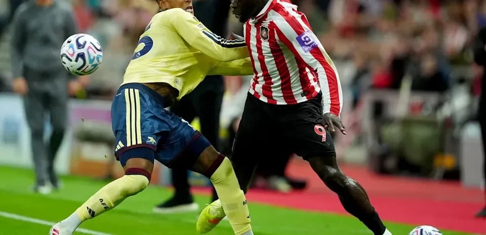 Players contesting for the ball during football match