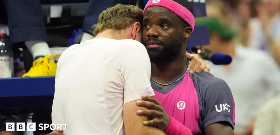 Two tennis players embracing during a match
