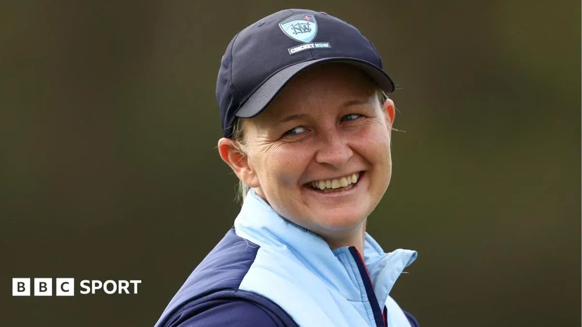 Smiling woman in cricket cap and jacket