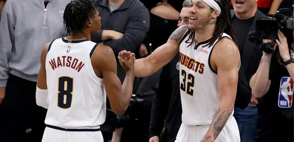 Two basketball players celebrating on court