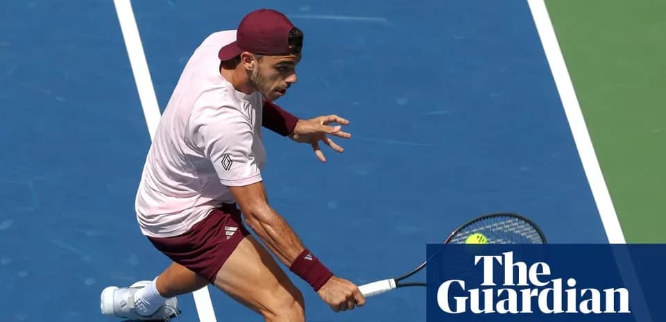 Tennis player executing a backhand shot on court