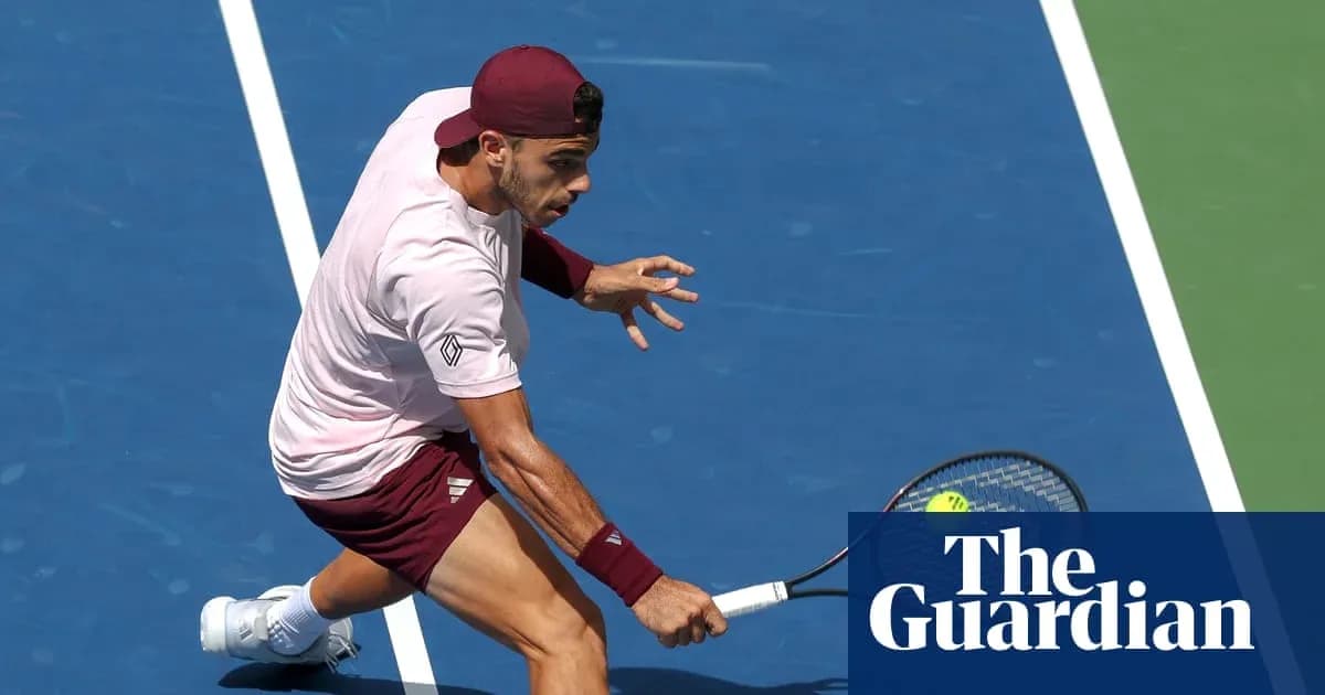 Tennis player executing a backhand shot on court