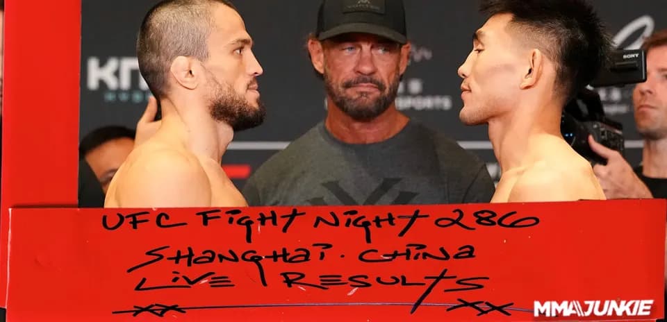 Two fighters facing each other at weigh-in event