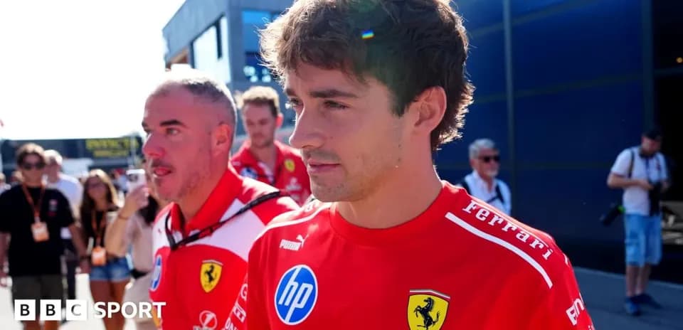 Ferrari team members walking in the paddock