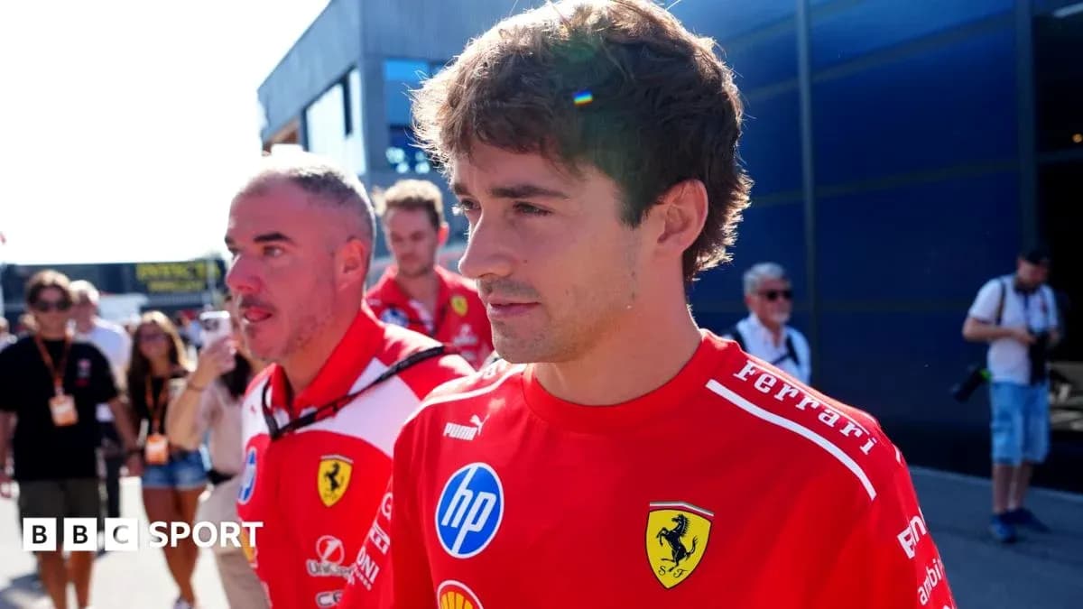 Ferrari team members walking in the paddock