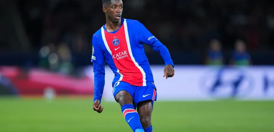 Player in PSG kit dribbling the ball on pitch