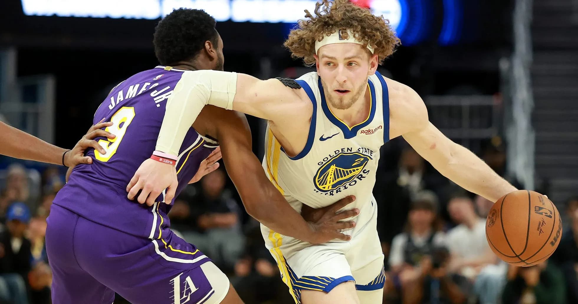 Player dribbling past defender during basketball game