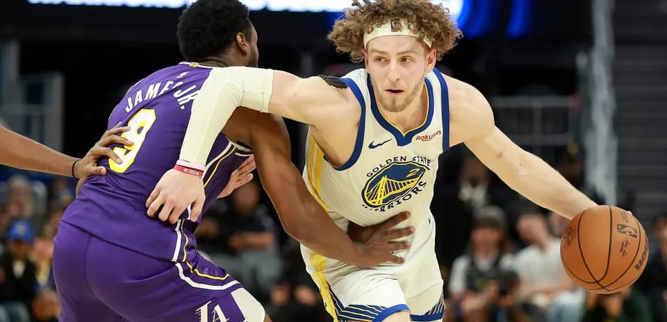 Player dribbling past defender during basketball game