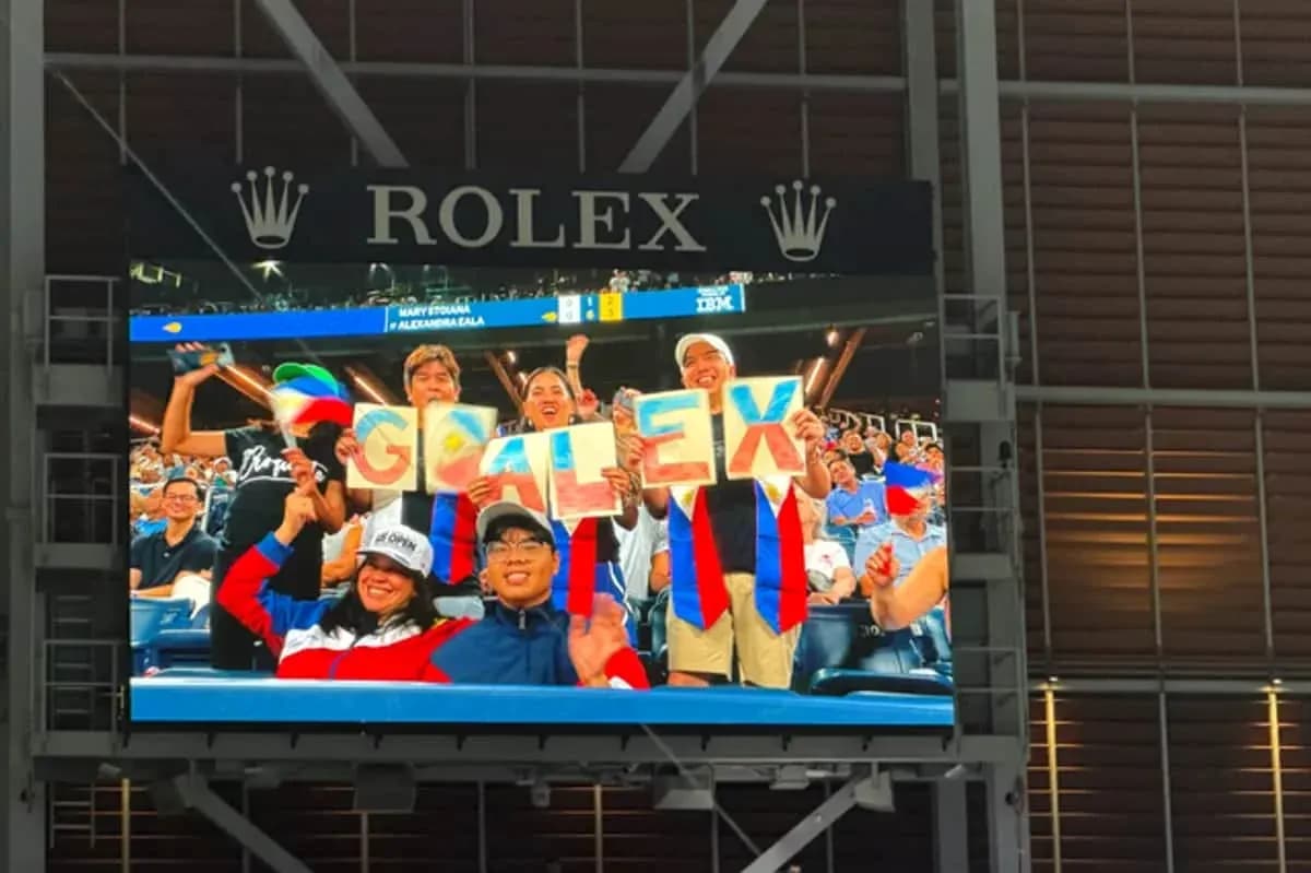 Fans cheering with signs at sporting event