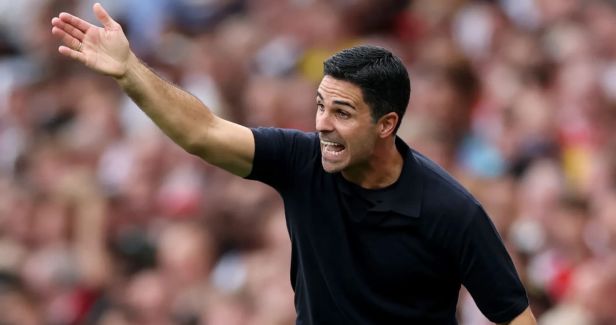 Manager gesturing during a match on the sidelines