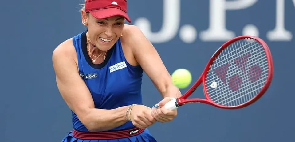 Player hitting tennis ball with racket during match