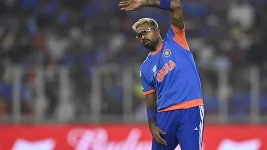 Cricketer waving during warm-up at stadium