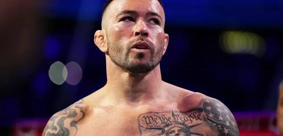 Bare-chested fighter with tattoos in boxing ring