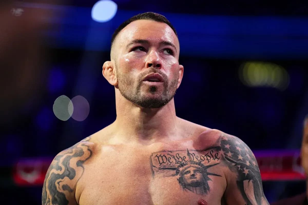 Bare-chested fighter with tattoos in boxing ring