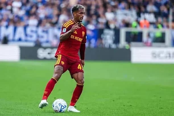 Player in red jersey dribbling ball during match