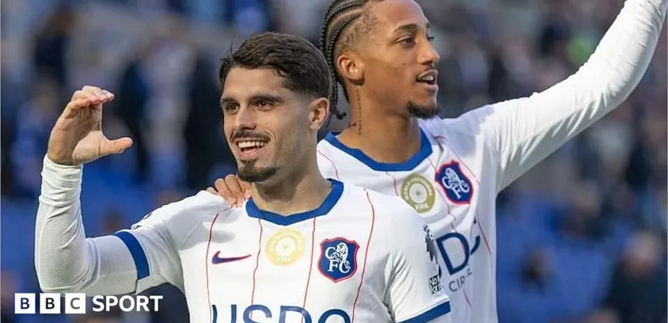 Two players celebrating on the field after a match