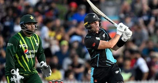 Batsman hitting a shot, wicketkeeper watching