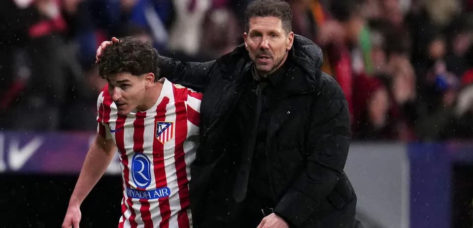 Atletico Madrid coach assisting player off field