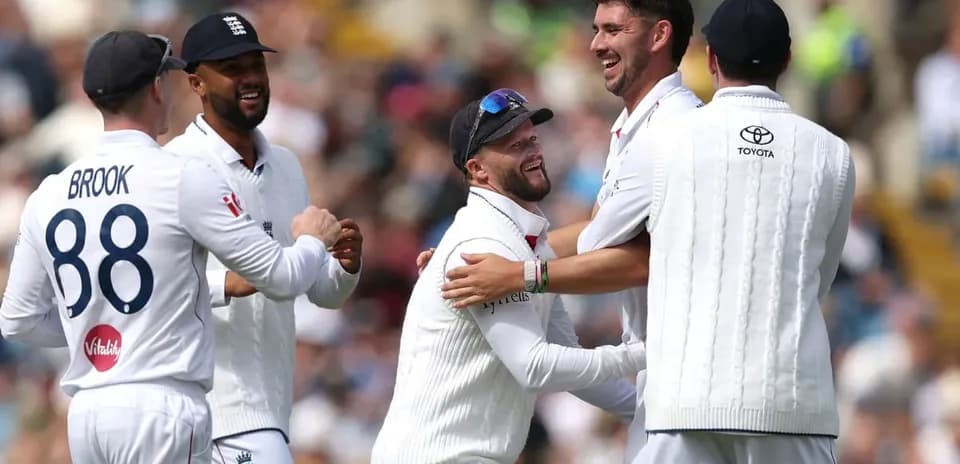 England cricket players celebrating a wicket on field