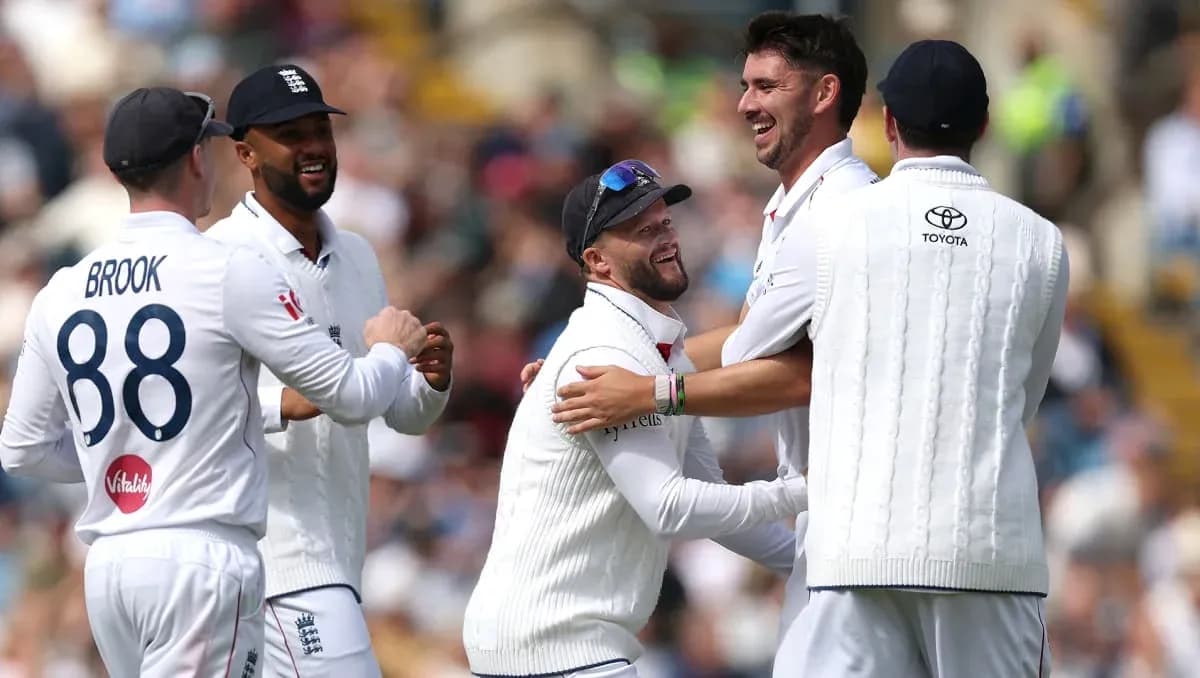 England cricket players celebrating a wicket on field