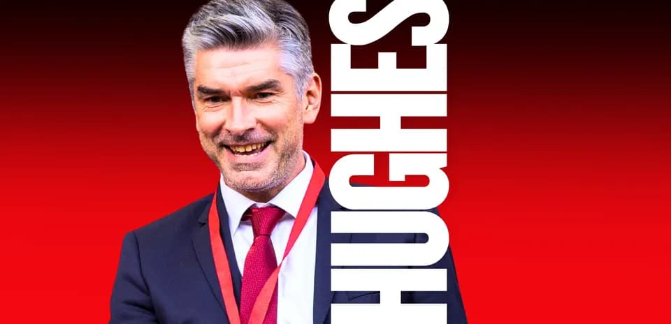 Man in suit smiling with a red background