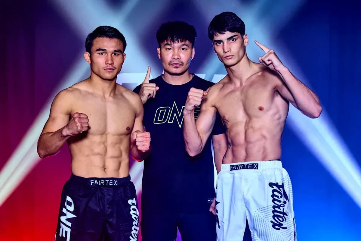 Two fighters posing with a coach before match