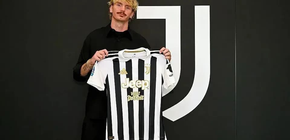 Player holding Juventus jersey at announcement event