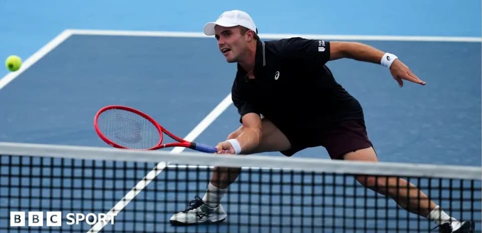 Player reaching for a tennis ball during match