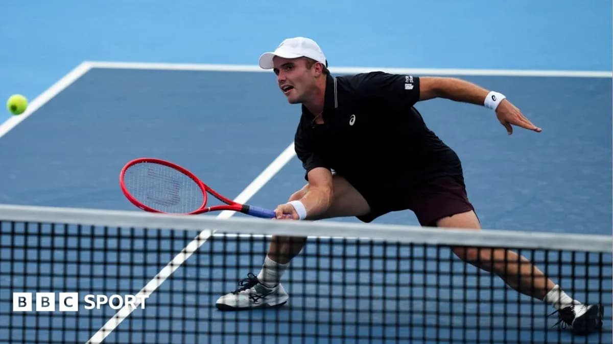 Player reaching for a tennis ball during match