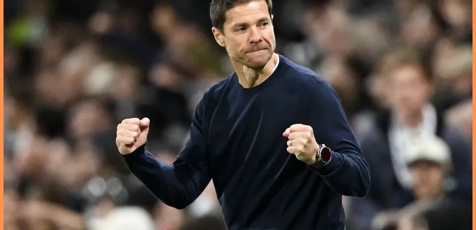Coach celebrating with clenched fists on sidelines