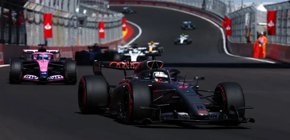 Formula 1 cars racing on a winding track