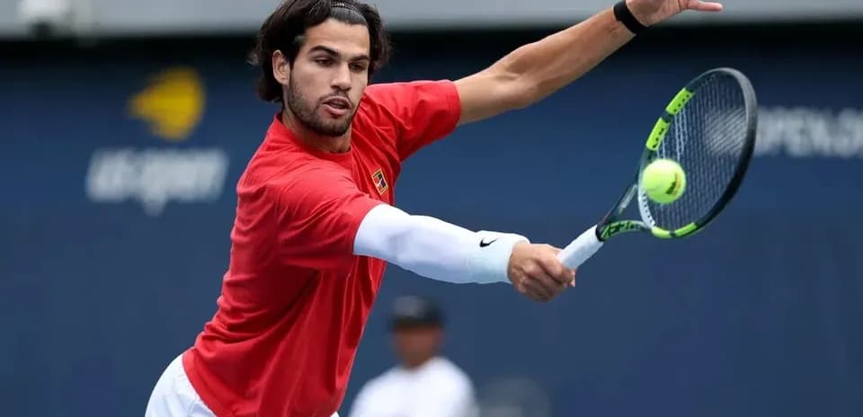 Player hitting a tennis ball during practice session