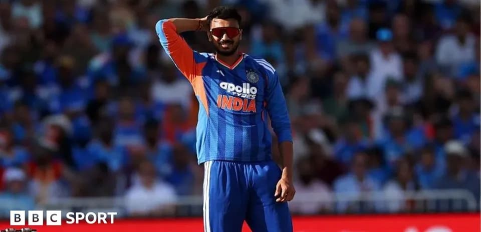 Cricketer in blue uniform gesturing during match