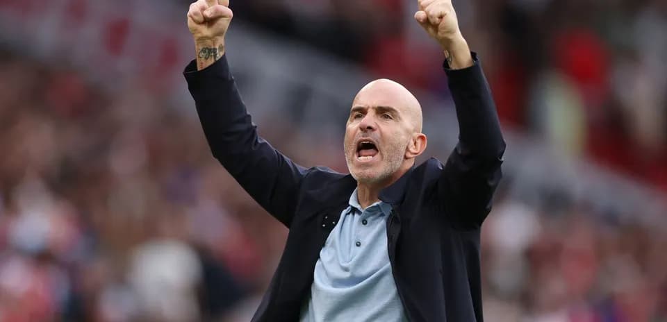 Coach celebrating with raised fists during match