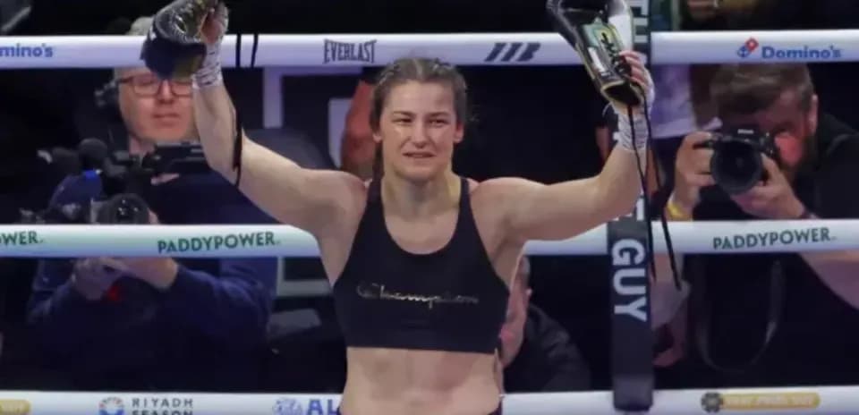 Female boxer celebrating victory in the ring